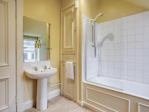 a bathroom with a sink and a shower and a tub at 6 Bed in Fort William oc-ca139 in Fassfern +26 photos