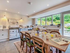 a large kitchen with a wooden table and chairs at 4 Bed in Kendal oc-sz535 in Kentmere