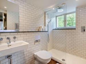 a bathroom with a sink and a toilet and a shower at 4 Bed in Kendal oc-sz535 in Kentmere +21 photos