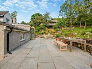 a patio with a bench and a table at 4 Bed in Kendal oc-sz535 in Kentmere