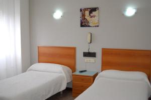 Säng eller sängar i ett rum på IRAIPE Gorbea Hotel