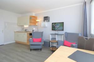 a kitchen and dining room with chairs and a table at Rüter 57 w in Westerland