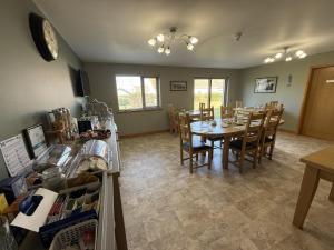 a large dining room with a table and chairs at Avalon Guest House in Orkney