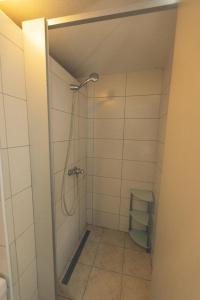 a bathroom with a shower with a glass door at Tamar Mountain hut in Rateče