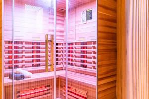 a glass shower in a bathroom with wooden walls at Lago Edera - Panoramablick in Hemfurth-Edersee +56 photos