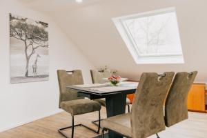 a dining room table with chairs and a skylight at Lago Edera - Seeblick in Hemfurth-Edersee