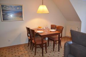 a dining room with a wooden table and chairs at Balmer See 28 Ferienwohnung mit direktem Seeblick in Balm