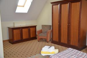 a bedroom with a bed and a cabinet and a chair at Balmer See 28 Ferienwohnung mit direktem Seeblick in Balm