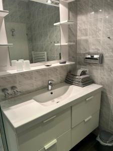 a bathroom with a white sink and a mirror at Alte Teestube Alte Teestube 57 in Norderney