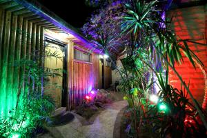 a house with christmas lights on the side of it at Sunset Inn in Eilat