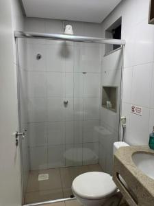 a bathroom with a shower with a toilet and a sink at Hotel Universal in Santarém +14 photos