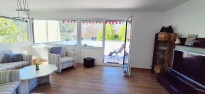 a living room with a couch and a television at Ferienwohnung Wagner in Neumagen-Dhron +33 photos