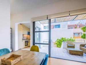 a living room with a table and a large glass door at Can montis in Palma de Mallorca