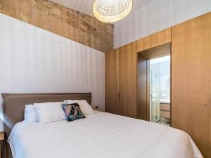 a bedroom with a large white bed and a chandelier at Can montis in Palma de Mallorca