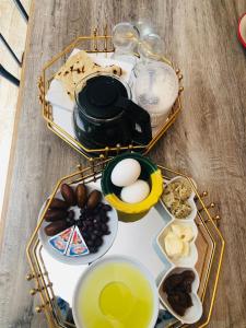 a table topped with two trays filled with food and drinks at Dar Mariem Douz in Douz