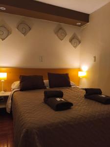 a bedroom with a large bed with clocks on the wall at Lido in Mar del Plata