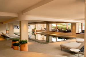 an open living room with a pool in a house at Iberostar Selection Jardín del Sol Suites - Adults Only in Santa Ponsa