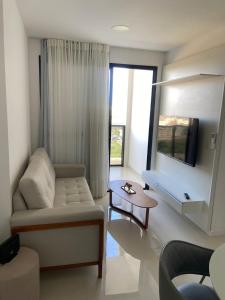 a living room with a couch and a table at Vila confort in Vila Velha