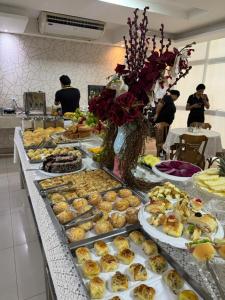 a buffet of pastries and desserts on a table at Hotel Universal in Santarém