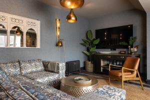 a living room with a couch and a table at Sanctuary Knocker in Durham