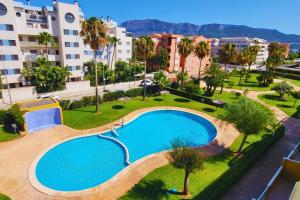 an overhead view of a swimming pool in a city at Attic Duplex Apartment with 4 terraces & 5 min walk to Beach in Denia