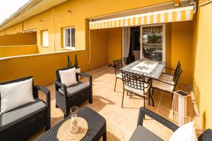 a patio with chairs and a table and a table and chairs at Attic Duplex Apartment with 4 terraces & 5 min walk to Beach in Denia