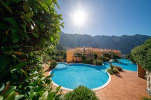 a view of a swimming pool with mountains in the background at Private Terrace Living - Blue Flag Beach & Family Retreat near Kotor in Gornji Orahovac