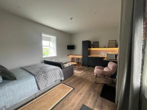 a bedroom with a bed and a desk and a chair at Crossdrum Courtyard Accommodation in Oldcastle