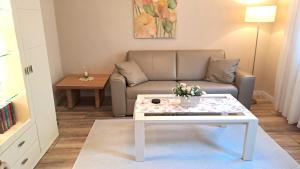a living room with a couch and a coffee table at Apartment Schlossblick - Top location in Idar-Oberstein