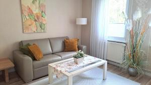 a living room with a couch and a coffee table at Apartment Schlossblick - Top location in Idar-Oberstein
