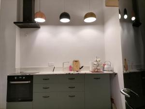 a kitchen with a sink and a stove at Center Apartment in Przemyśl