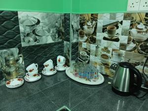a display case with a bunch of cups and dishes at Ocean waves in Trincomalee