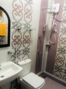a bathroom with a shower and a toilet and a sink at Ocean waves in Trincomalee
