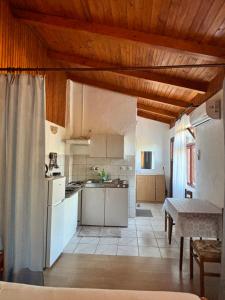 a kitchen with white appliances and a table in a room at Apartman Mira in Karlobag