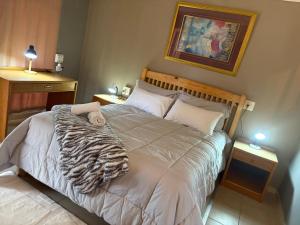 a bedroom with a bed with a zebra blanket at No7 Mc Intyre Guest House in Sasolburg +13 photos