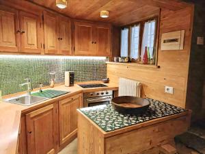 a kitchen with wooden cabinets and a bowl on a counter at Baita Genepy - Charme Alpino in Pietra in Alagna Valsesia +24 photos