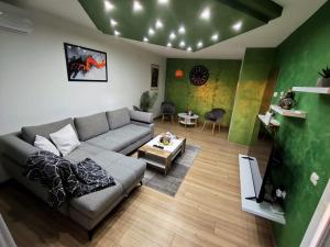 a living room with a couch and a table at Apartment Aby - Free Parking & Self Check-in in Slavonski Brod