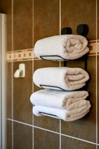 a stack of towels on a towel rack in a bathroom at Super appartement à lumio in Lumio +38 photos