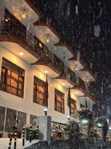 a lobby of a building with snow on the ceiling at Hotel Sumit in Kausani
