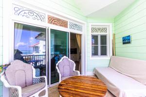 a living room with a couch and a table at Victorian Condominium, Cabarete! in Cabarete