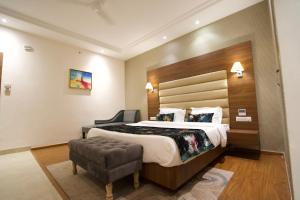 a hotel room with a large bed and a chair at RANIKOTHI BOUTiQUE HOTEL in Nagpur
