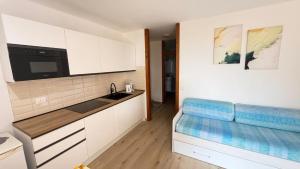 a kitchen with white cabinets and a blue counter top at Lake Garda Apartment - Panorama in Brenzone sul Garda +21 photos