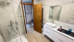 a bathroom with a sink and a glass shower at Lake Garda Apartment - Panorama in Brenzone sul Garda