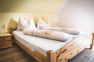 a bedroom with two beds with white sheets and pillows at Weingut Gaube in Leutschach