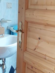 a door in a bathroom with a sink at Weingut Gaube in Leutschach