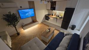 an overhead view of a living room with a couch and a tv at Sea Nest in Šušanj