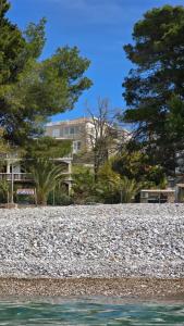 a large gravel area with trees and a building at Sea Nest in Šušanj