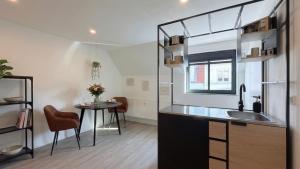 a small kitchen with a sink and a table at City Apartments in Rostock +38 photos