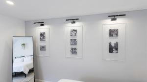 a room with a bed and three pictures on the wall at City Apartments in Rostock