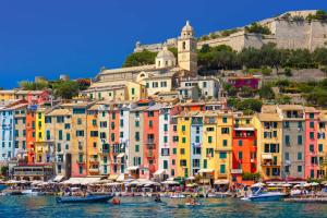 a group of buildings on a hill with boats in the water at ZenZone House in La Spezia